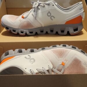 On Running White and Orange Athletic Shoes